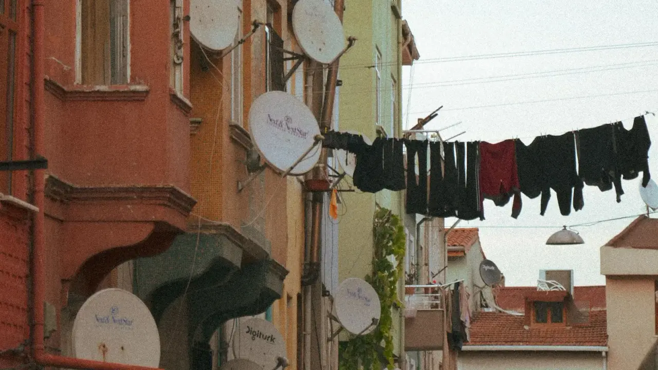 Balkonlarında uydu çanakları bulunan bir şehir sokağı